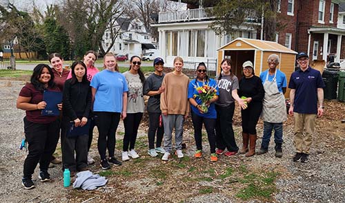The organizers of the garden at Liberty Grace Church pose with student and faculty volunteers from CCBC