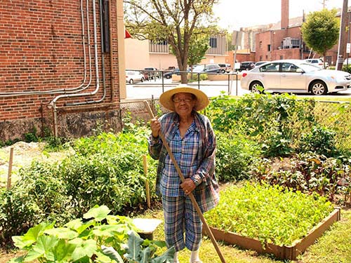 Maxine Nicholas stands in the garden